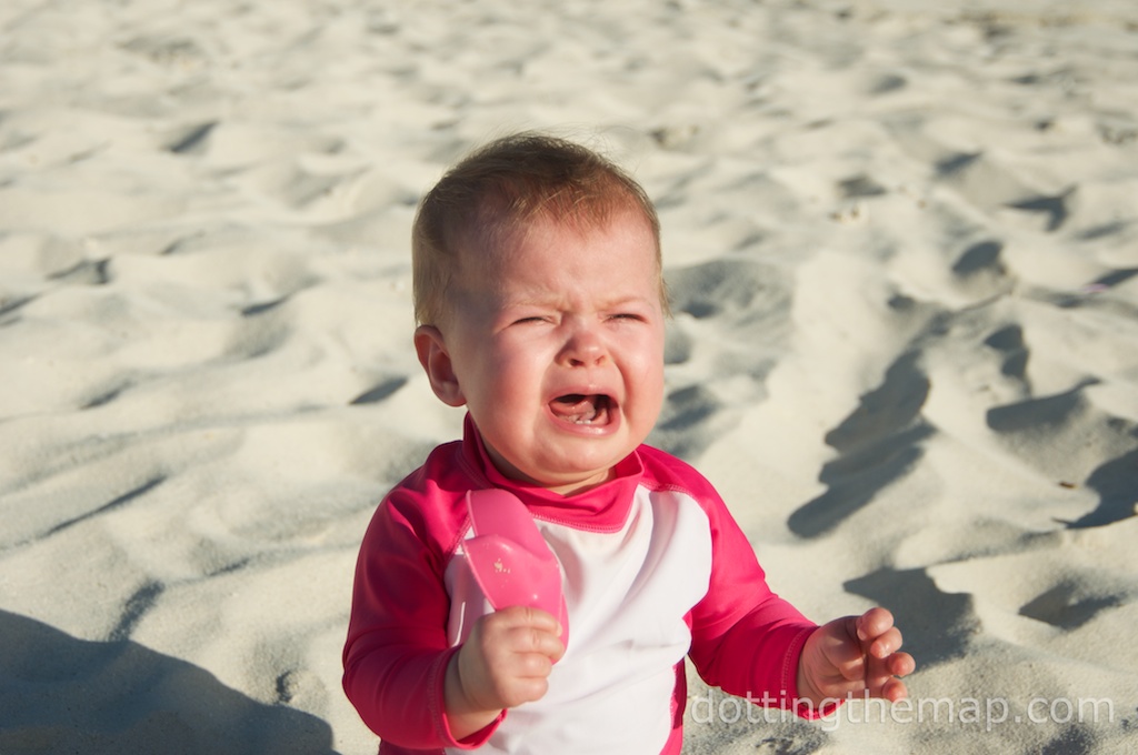 crying baby on beach